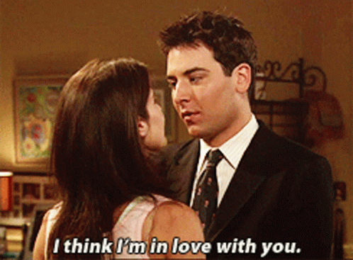 The image is a scene from How I Met Your Mother featuring Ted Mosby, played by Josh Radnor, looking into Robin Scherbatsky's eyes. The caption reads, "I think I'm in love with you," capturing Ted's emotional confession to Robin.