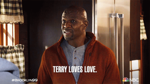 The image is from Brooklyn Nine-Nine featuring Terry Jeffords, played by Terry Crews. Terry is smiling warmly, and the caption reads, "Terry loves love." This captures his affectionate and expressive personality, emphasizing his love for all things related to family and affection.