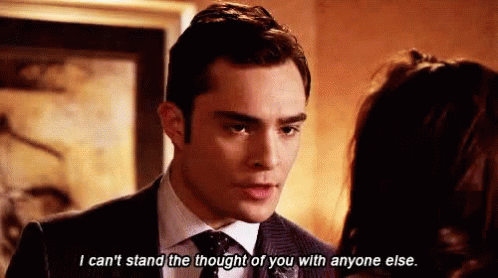 The image shows a scene from Gossip Girl featuring Chuck Bass, played by Ed Westwick, speaking intensely to Blair Waldorf. The caption reads, "I can't stand the thought of you with anyone else," highlighting Chuck's emotional conflict and possessiveness in his relationship with Blair.